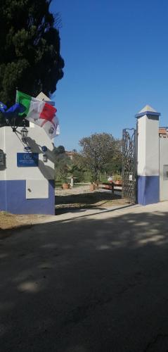 a gate on a street next to a road at SERRA E MESU Affittacamere in Magomadas