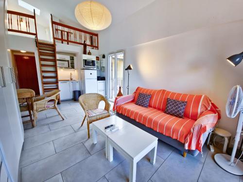 un salon avec un canapé et une table dans l'établissement Studio Saint-Clair, au Lavandou