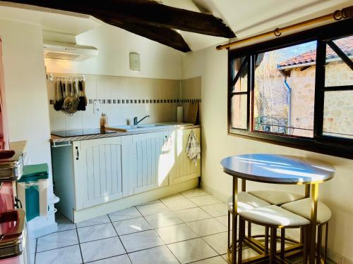 a kitchen with a table and a sink at Paloma in Figeac