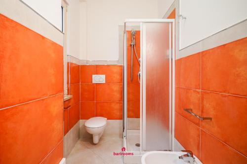 a bathroom with a shower and a toilet and a sink at Barirooms Piccinni in Bari