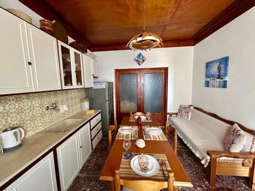 a living room with a couch and a table at BlueSunnyParadise in Glóssa
