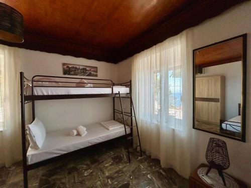 a room with two bunk beds and a mirror at BlueSunnyParadise in Glóssa