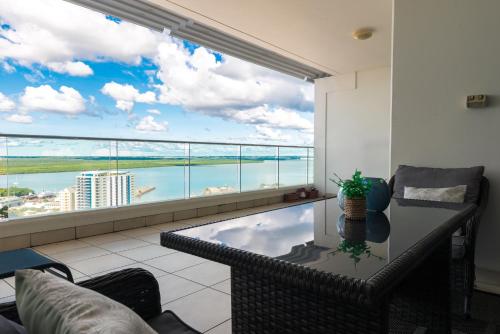 a living room with a view of the water at Darwin Harbour Suites in Darwin