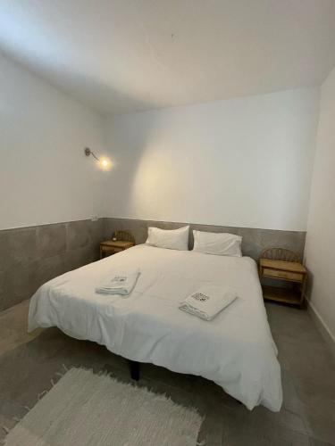 a bedroom with a white bed with two towels on it at Casthotels Leblon in El Arenal