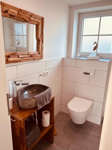 a bathroom with a sink and a toilet at Ferienhaus Waldweg in Wienhausen
