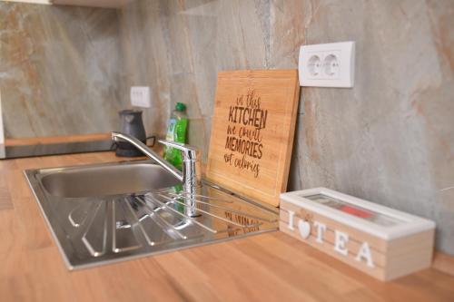 a kitchen counter with a sink and a cutting board at Apartmani Silver view Zlatibor in Zlatibor