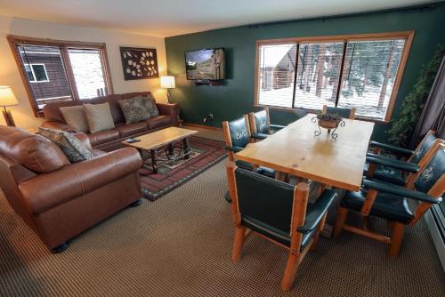 a living room with a couch and a table at Timber Creek Chalets- 14 chalet in Estes Park