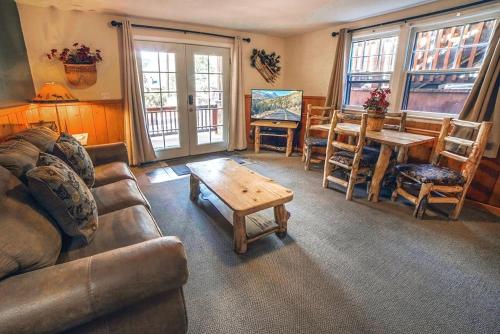 a living room with a couch and a table and chairs at Lawn Lane A - #3382 in Estes Park