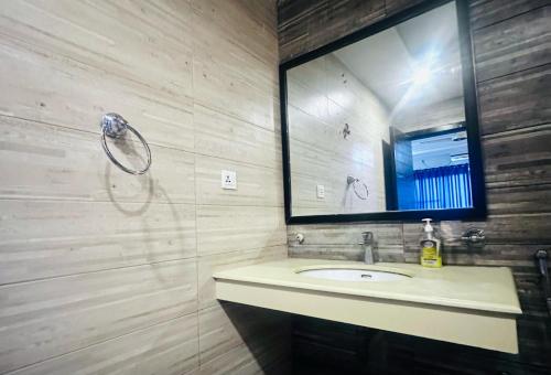 a bathroom with a sink and a mirror at Executive appartment in bahria hieghts 1 in Rawalpindi