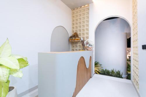 a room with a hallway with a wooden door at Tamanna Villa Uluwatu in Uluwatu