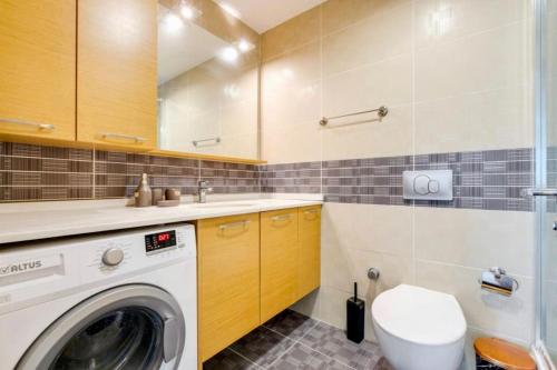 a bathroom with a washer and dryer in it at Residence with city view in Basaksehir