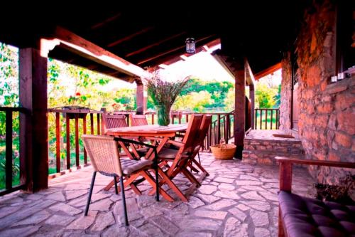 a wooden table and chairs on a patio at Rural Médulas Viviendas de uso turistico 2 y Casas rurales 2 in Las Médulas