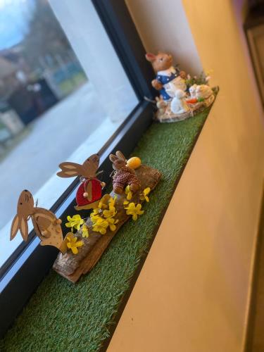 a window sill with some toy figurines on it at Auberge du château de Joux in La Cluse et Mijoux