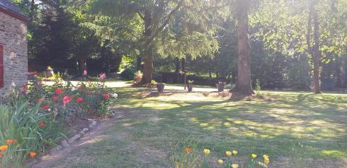 a garden with trees and flowers in a park at Maison de campagne Talara in Locqueltas