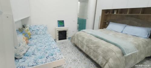 a bedroom with a large bed and a fireplace at DonnaSofia in Cetara