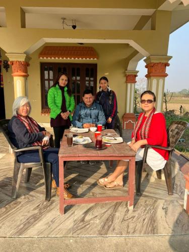a group of people sitting around a table at Friend's Home Stay in Jhawāni