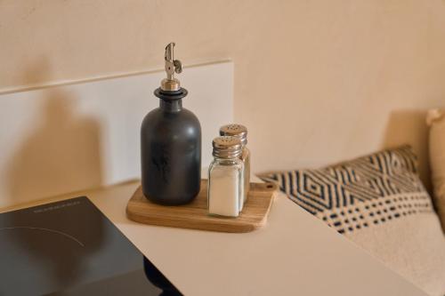 a bottle on a table next to a laptop at Logement atypique de 45m2, en centre ville de Cognac in Cognac