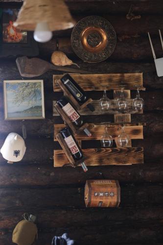a table with wine bottles and other items on it at Shtepizat e Rames Agroturizem in Librazhd
