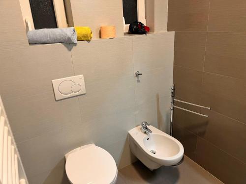 a small bathroom with a toilet and a sink at Riverbridge Apartments Prague in Prague