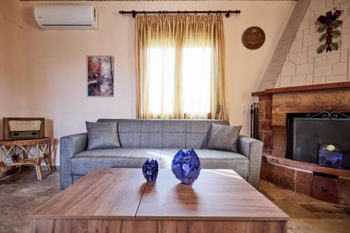 a living room with a couch and a table at White lilies the house of gourmet flavours in Chios