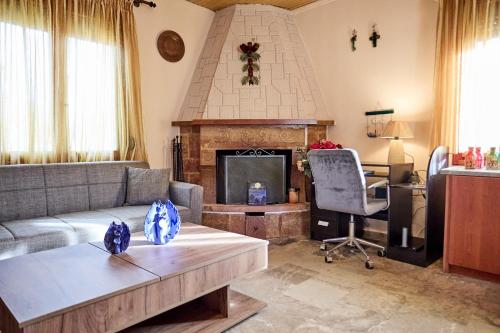 a living room with a couch and a fireplace at White lilies the house of gourmet flavours in Chios