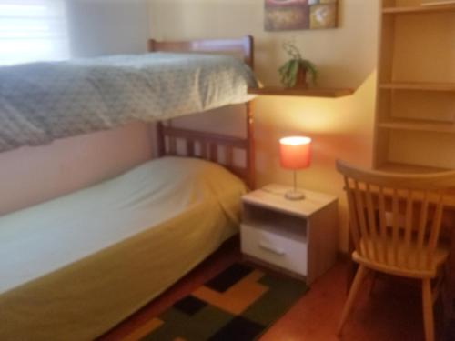 a bedroom with two bunk beds and a lamp at Hogar Zen in Puerto Saavedra