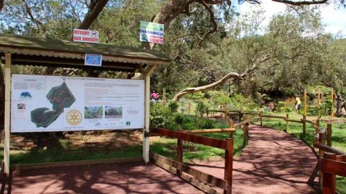 a interpretive sign at a park with a tree at Villa Tamara les hauts in Le Tampon