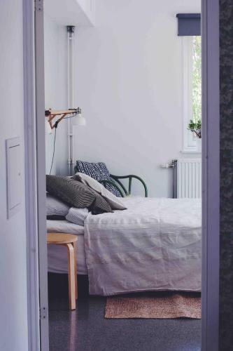 a bedroom with a bed and a chair and a window at Spacious scenic in Stockholm