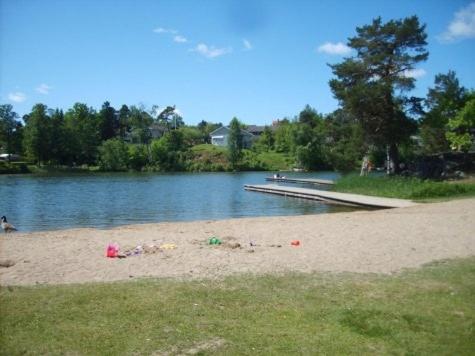 a beach with a pier and a body of water at Spacious scenic in Stockholm