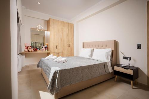 a bedroom with a large bed with white shoes on it at Polixenys home in Daratso