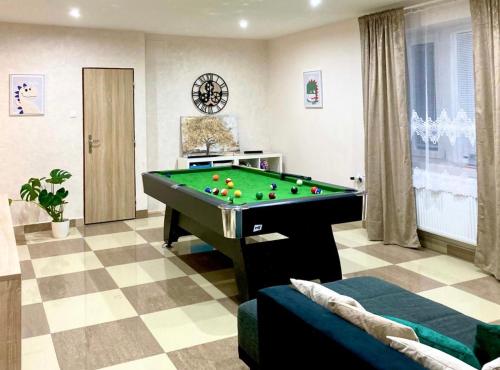 a living room with a pool table at Olivia Relax & Adventure in Hliník nad Hronom