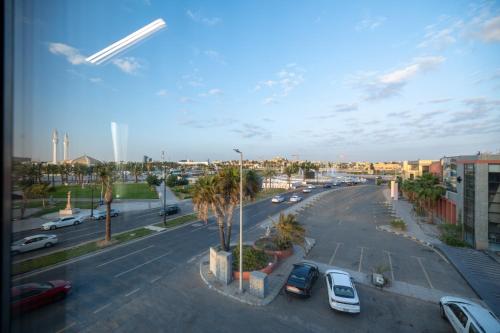 a view of a street with cars parked in a parking lot at nasim aizraq hotel فندق نسيم ازرق in Jeddah