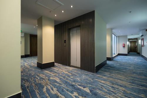 a hallway of an office building with a row of doors at nasim aizraq hotel فندق نسيم ازرق in Jeddah