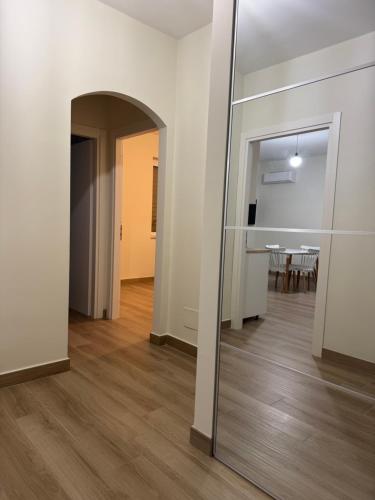 a hallway with a mirror and a dining room at mare & colori in Trebisacce