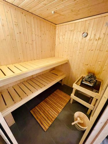 a small wooden sauna with a bench in it at LITELIVING Cozy Suite - Sauna - Balkon - Parken - BBQ - Modern & Gemütlich in Möhnesee