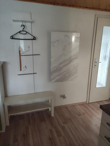 a white room with a bench and a window at Ferienwohnung Beck in Buttstädt