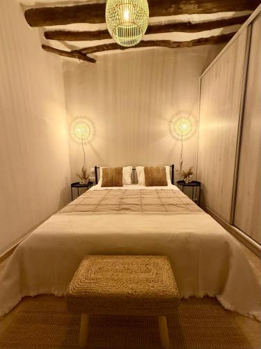 a bedroom with a large bed with a chandelier at Theros in Karistos