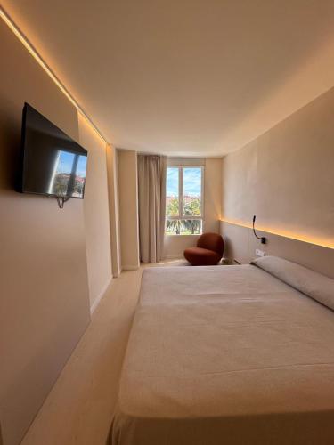 a hotel room with two beds and a flat screen tv at El Globo in Valencia