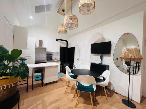 a kitchen and dining room with a table and chairs at Villa Mia in Hayange