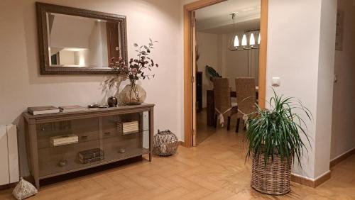 a living room with a dresser and a mirror at Casa en Valencia, piscina, cerca de golf, playas, moto Gp in Valencia