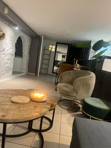 a room with a table with a candle on it at Beachroom Appartement in Scheveningen
