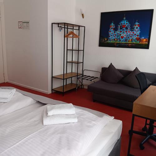a living room with two beds and a couch at Hotel Amelie Berlin in Berlin
