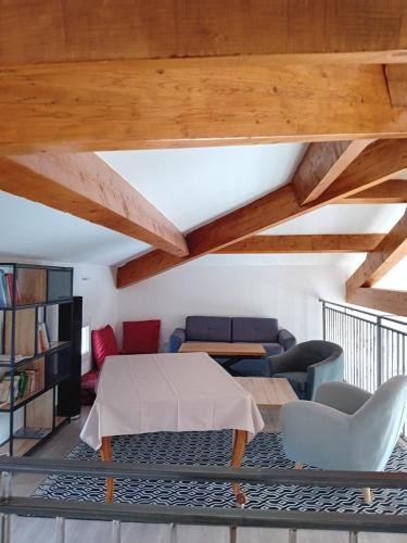 - un salon avec des plafonds en bois, une table et des chaises dans l'établissement Villa Pont du Gard, à Castillon-du-Gard