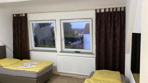 a bedroom with two beds and a window at CASA Del SUR in Braunschweig
