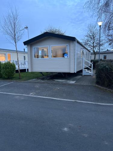 a tiny house is parked in a parking lot at Haven Cala gran 2026 spring summer autumn winter breaks up to January 2027 A full action camp for all ages disabled friendly Fleetwood Blackpool Entire home 6 people seaside caravan park in Fleetwood
