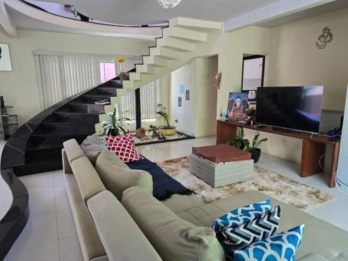 un salon avec un canapé et un escalier dans l'établissement RSF itapua, à Salvador