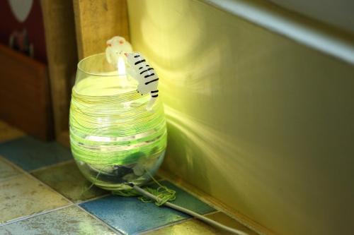 a toothbrush sitting in a glass jar next to a wall at Huxi B&B in Jian