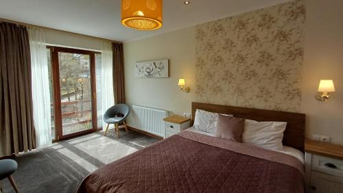 a hotel room with a bed and a window at Nobila in Sinaia