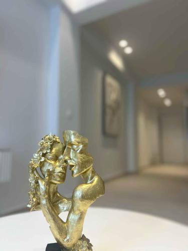 a bronze statue of two people kissing in a room at ZISE Luxury Apartments in Corfu