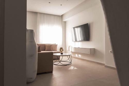 a living room with a couch and a table at ZISE Luxury Apartments in Corfu Town